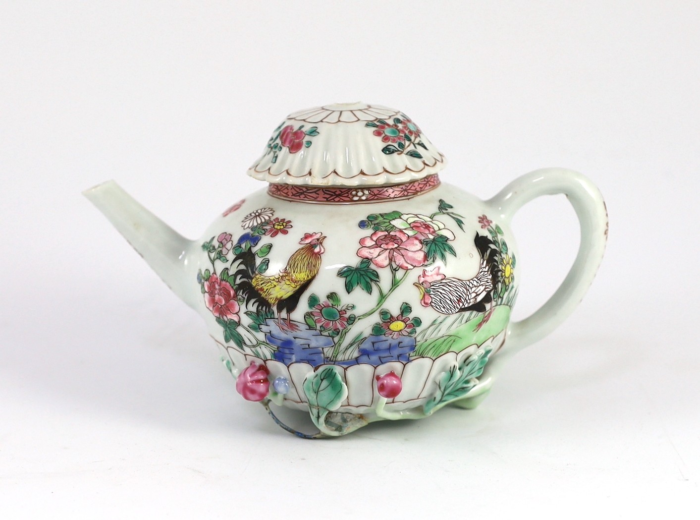 A Chinese famille rose chrysanthemum moulded teapot, early Qianlong period, painted with a cockerel amongst flowers, on a cage work base, 10 cms high